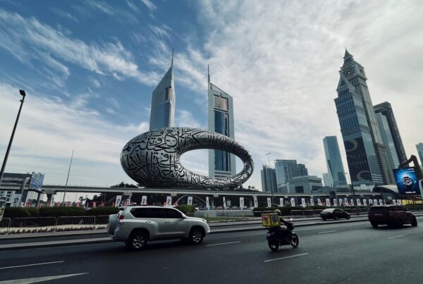 a city street with cars and motorcycles on it