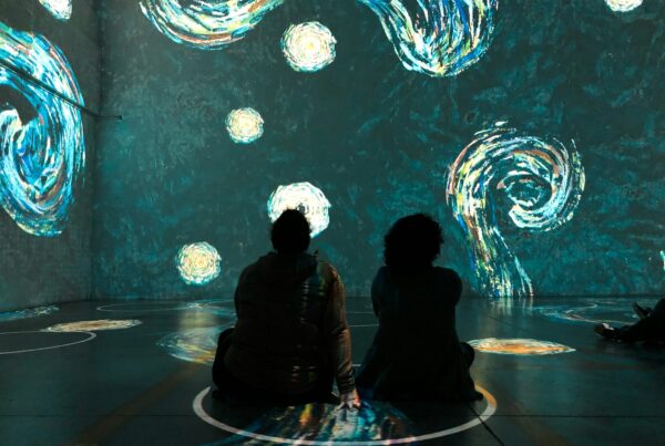 People sitting in physical distancing circles at Immersive Van Gogh Exhibit in Toronto Canada